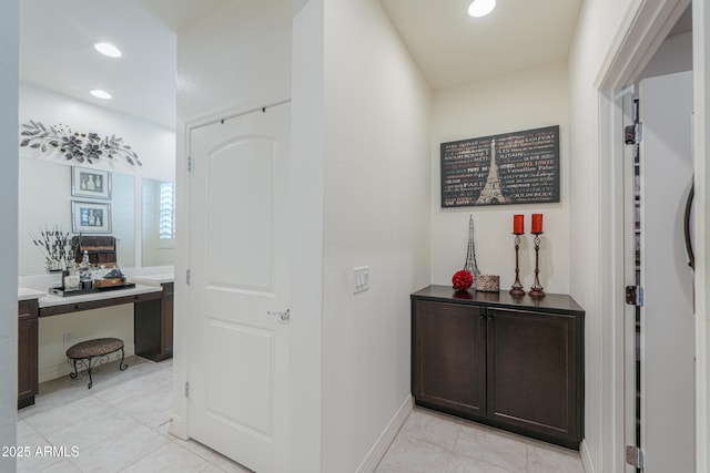 hall featuring light tile patterned floors