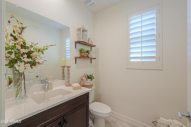 bathroom featuring vanity, tile patterned floors, and toilet