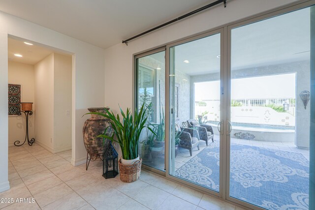 entryway with plenty of natural light and light tile patterned floors