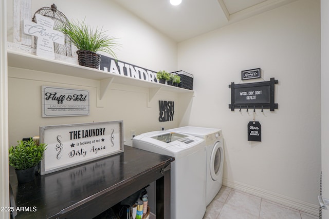 washroom with light tile patterned floors and washing machine and dryer