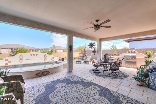 view of patio featuring an outdoor kitchen, area for grilling, and ceiling fan