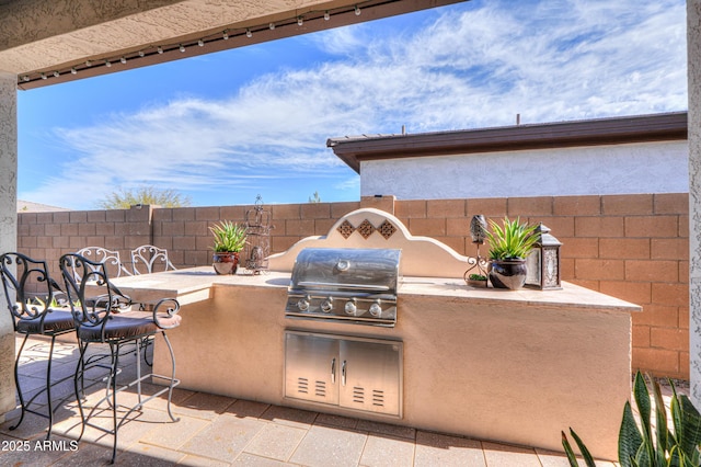 view of patio with a grill and exterior kitchen