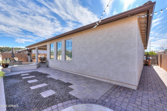 view of side of home with a patio