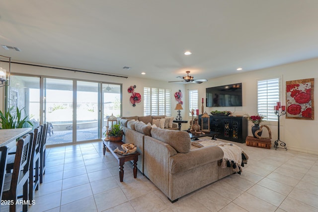 tiled living room with ceiling fan