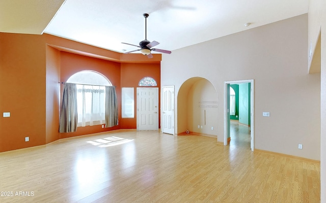 4484 Desert Springs Trl, Sierra Vista, AZ 85635 - spare room featuring a ceiling fan, light wood-type flooring, arched walkways, baseboards, and a smoke detector