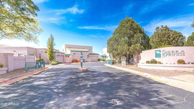 4484 Desert Springs Trl, Sierra Vista, AZ 85635 - view of asphalt road with curbs, a gate, and a gated entry