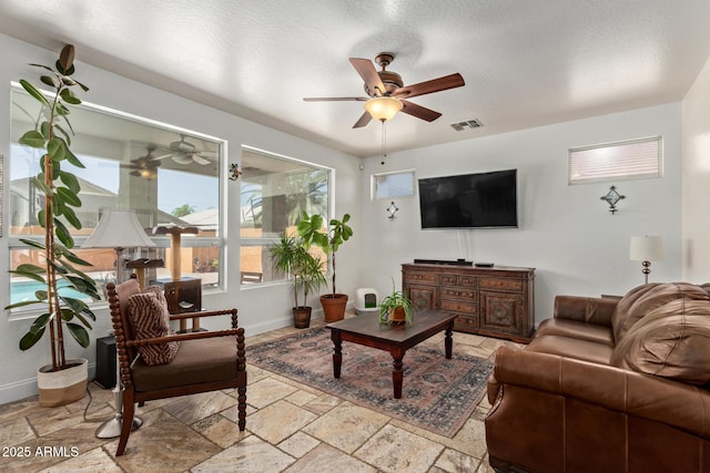 4331 E Redwood Ln, Phoenix, AZ 85048 - living area with a ceiling fan and stone tile floors