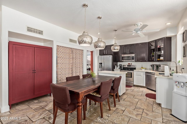 4331 E Redwood Ln, Phoenix, AZ 85048 - dining space with stone tile floors, ceiling fan, and recessed lighting