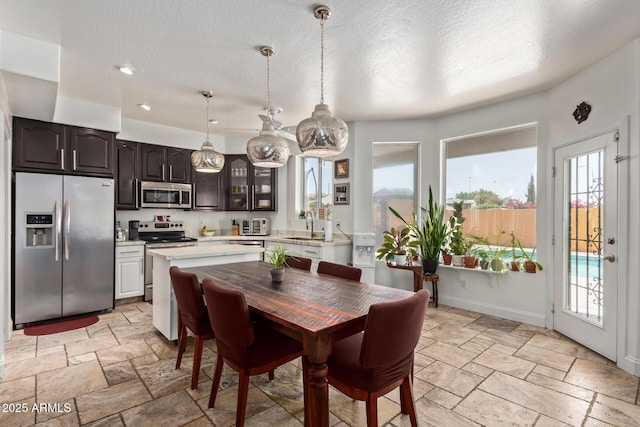 4331 E Redwood Ln, Phoenix, AZ 85048 - dining area featuring plenty of natural light, stone tile floors, a textured ceiling, and recessed lighting