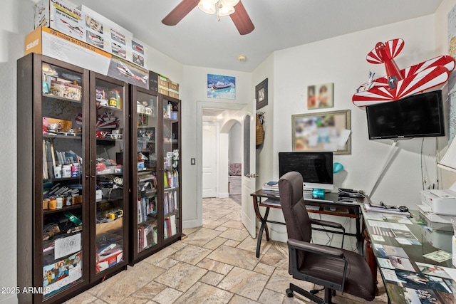 4331 E Redwood Ln, Phoenix, AZ 85048 - office with stone tile flooring, arched walkways, and a ceiling fan
