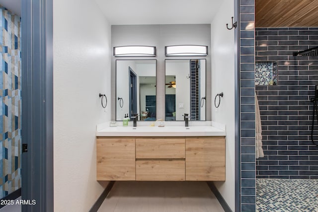 7102 E Kalil Dr, Scottsdale, AZ 85254 - full bath featuring tiled shower, double vanity, baseboards, and ceiling fan