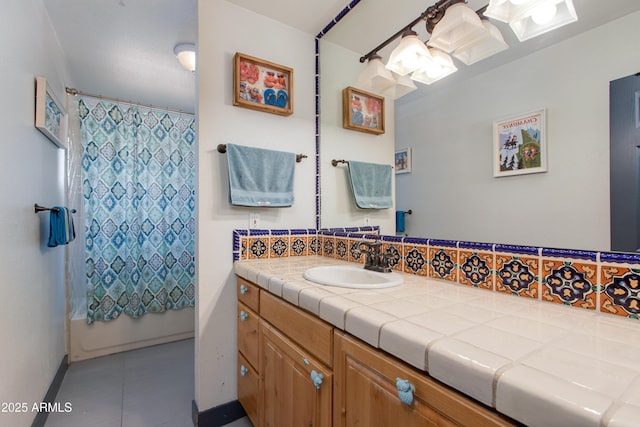 7102 E Kalil Dr, Scottsdale, AZ 85254 - full bathroom featuring vanity, shower / bath combo with shower curtain, baseboards, tasteful backsplash, and tile patterned floors