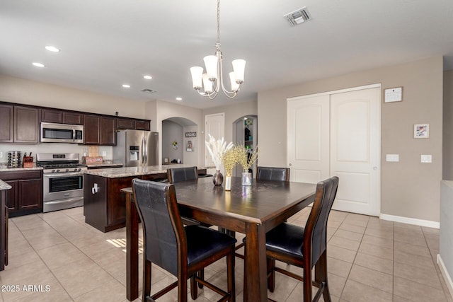 dining room featuring light tile patterned floors, visible vents, arched walkways, and recessed lighting