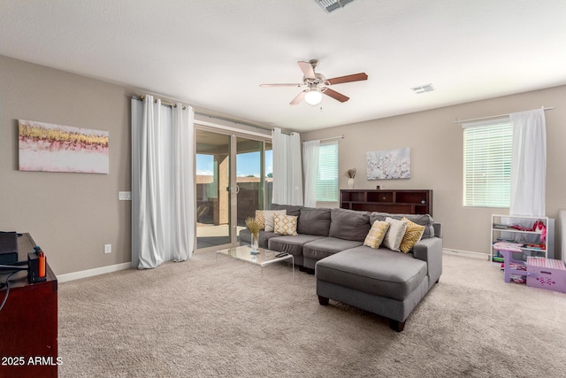 living area with carpet floors, plenty of natural light, and baseboards