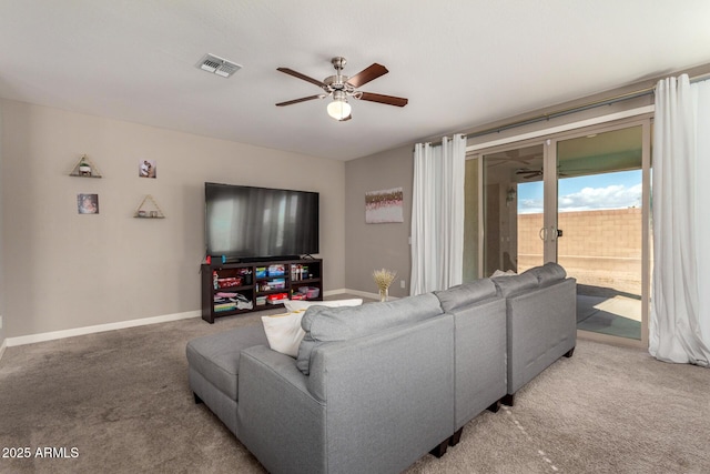 carpeted living room featuring baseboards, visible vents, and a ceiling fan