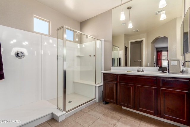 bathroom featuring a stall shower, visible vents, vanity, and tile patterned floors