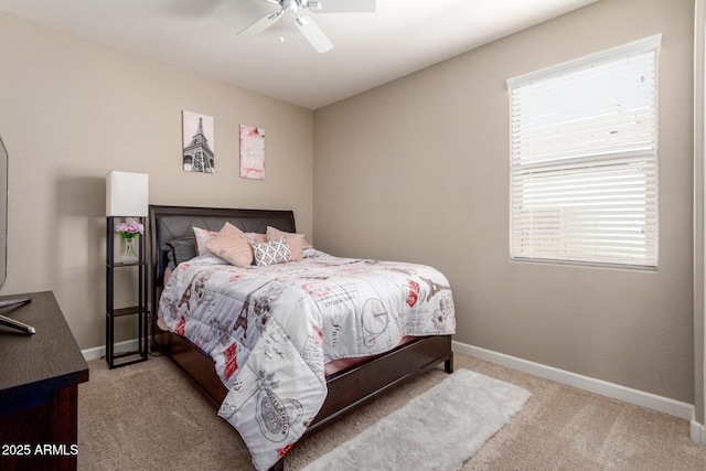 carpeted bedroom with a ceiling fan and baseboards