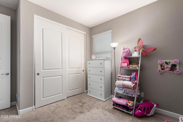 game room with baseboards and light colored carpet