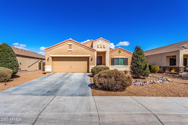 mediterranean / spanish house with a garage, a tile roof, driveway, and stucco siding