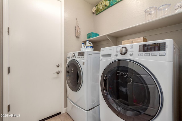 laundry room with laundry area, light tile patterned flooring, and washer and dryer