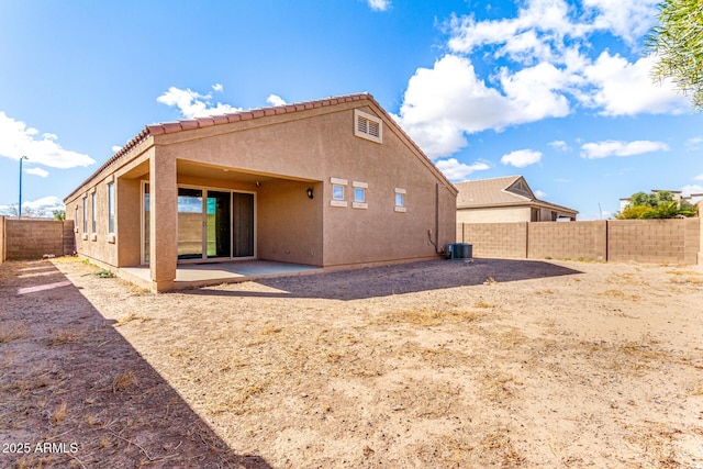 back of house with cooling unit, a fenced backyard, a patio, and stucco siding