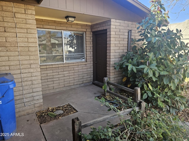 property entrance with brick siding