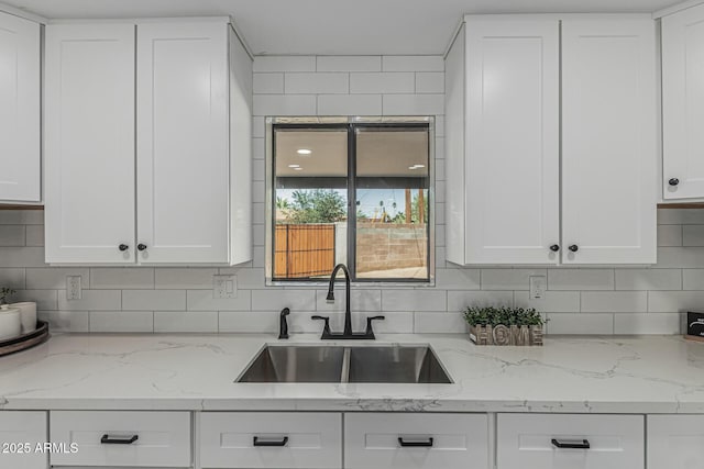 4441 N 27th Dr, Phoenix, AZ 85017 - kitchen with a sink, white cabinets, and tasteful backsplash