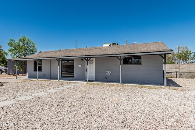 4441 N 27th Dr, Phoenix, AZ 85017 - back of property with fence, a shingled roof, a patio, and brick siding