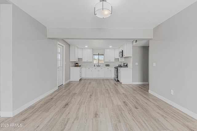 4441 N 27th Dr, Phoenix, AZ 85017 - unfurnished living room with a sink, light wood finished floors, baseboards, and recessed lighting