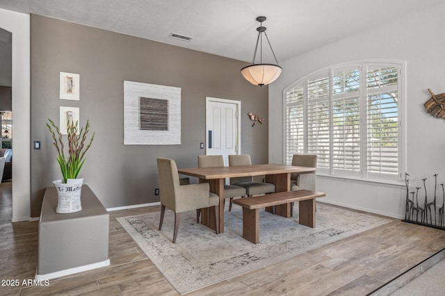 dining area with hardwood / wood-style floors