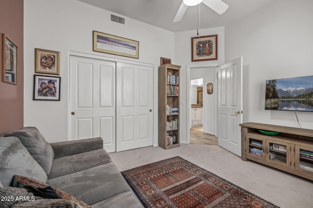 living room with light carpet and ceiling fan