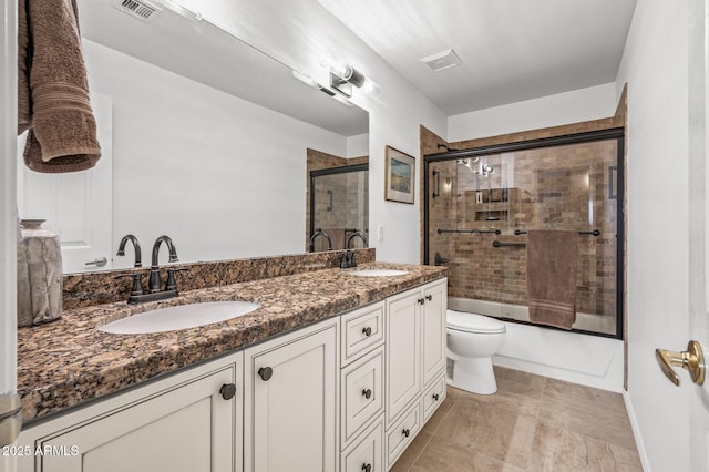 full bathroom featuring enclosed tub / shower combo, vanity, toilet, and tile patterned floors