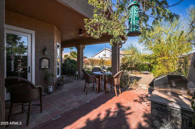 view of patio with grilling area, area for grilling, and ceiling fan