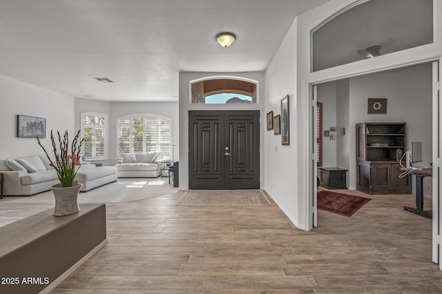 foyer entrance with light wood-type flooring