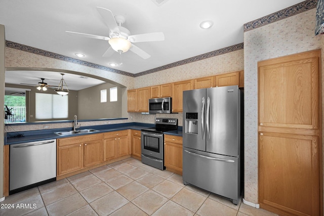 kitchen with ceiling fan, stainless steel appliances, sink, and light tile patterned flooring