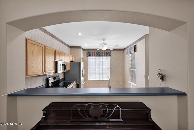 kitchen with ceiling fan, appliances with stainless steel finishes, and light brown cabinets