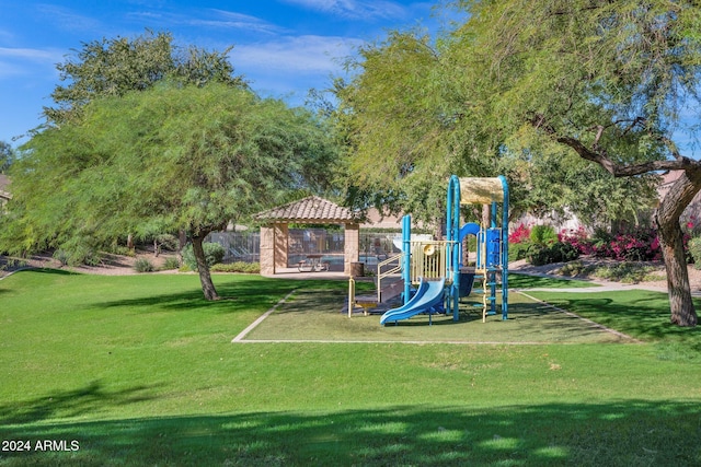 view of playground with a gazebo and a lawn