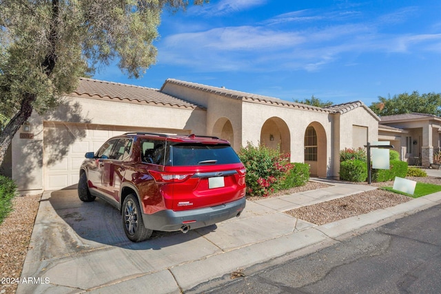 mediterranean / spanish house with a garage