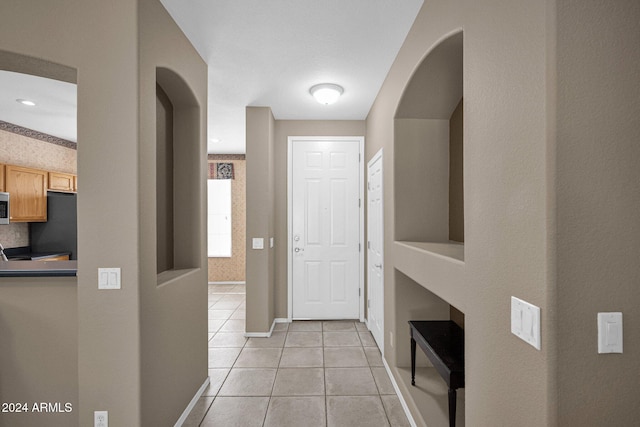 entrance foyer featuring light tile patterned floors