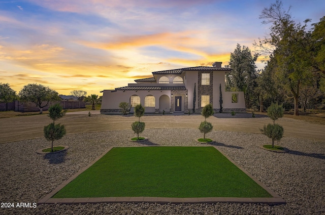 mediterranean / spanish-style house featuring a yard