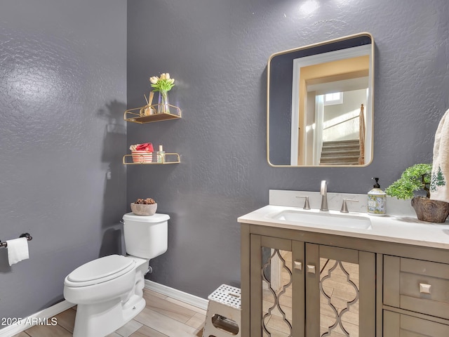 bathroom featuring tile patterned floors, vanity, and toilet