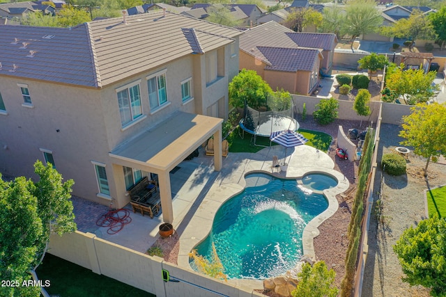 view of pool with a trampoline and a patio area