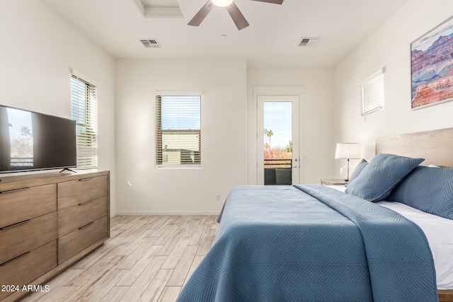 bedroom with ceiling fan, light hardwood / wood-style flooring, and access to exterior