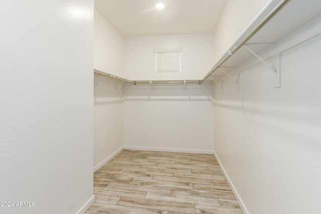 walk in closet featuring light hardwood / wood-style flooring