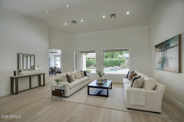 7214 E Rustling Pass, Scottsdale, AZ 85255 - living room with light wood-type flooring, baseboards, recessed lighting, and a high ceiling