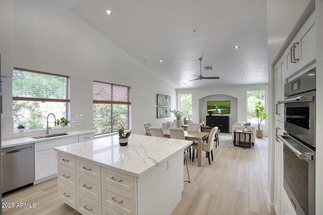 7214 E Rustling Pass, Scottsdale, AZ 85255 - kitchen featuring stainless steel appliances, a sink, a ceiling fan, a center island, and open floor plan