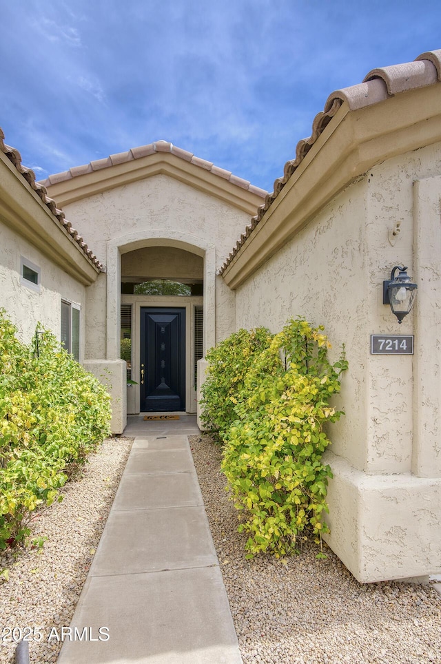 7214 E Rustling Pass, Scottsdale, AZ 85255 - view of exterior entry featuring stucco siding and a tiled roof