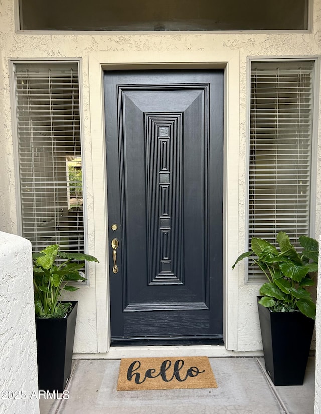 7214 E Rustling Pass, Scottsdale, AZ 85255 - doorway to property featuring stucco siding