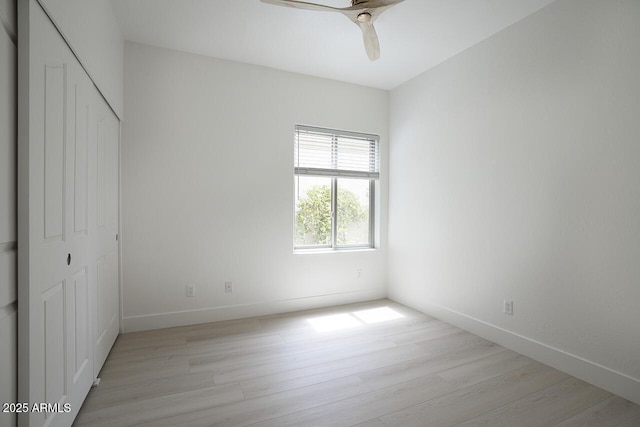 7214 E Rustling Pass, Scottsdale, AZ 85255 - unfurnished bedroom featuring light wood-style floors, a closet, baseboards, and a ceiling fan