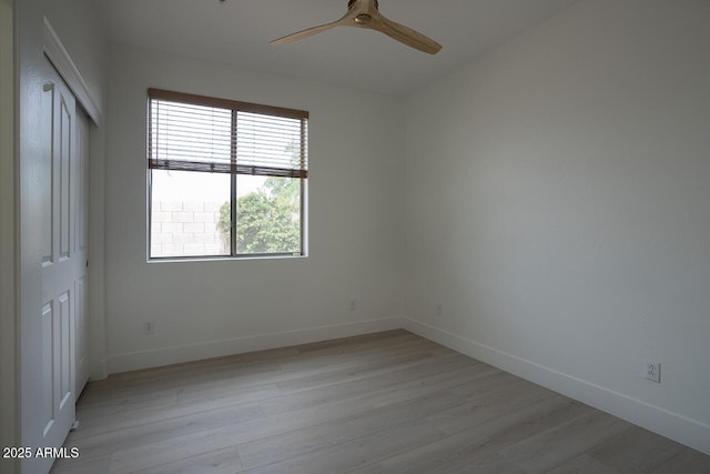 7214 E Rustling Pass, Scottsdale, AZ 85255 - unfurnished bedroom featuring light wood finished floors, baseboards, and a closet